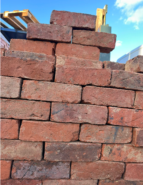 Handmade reclaimed bricks stacked on pallets